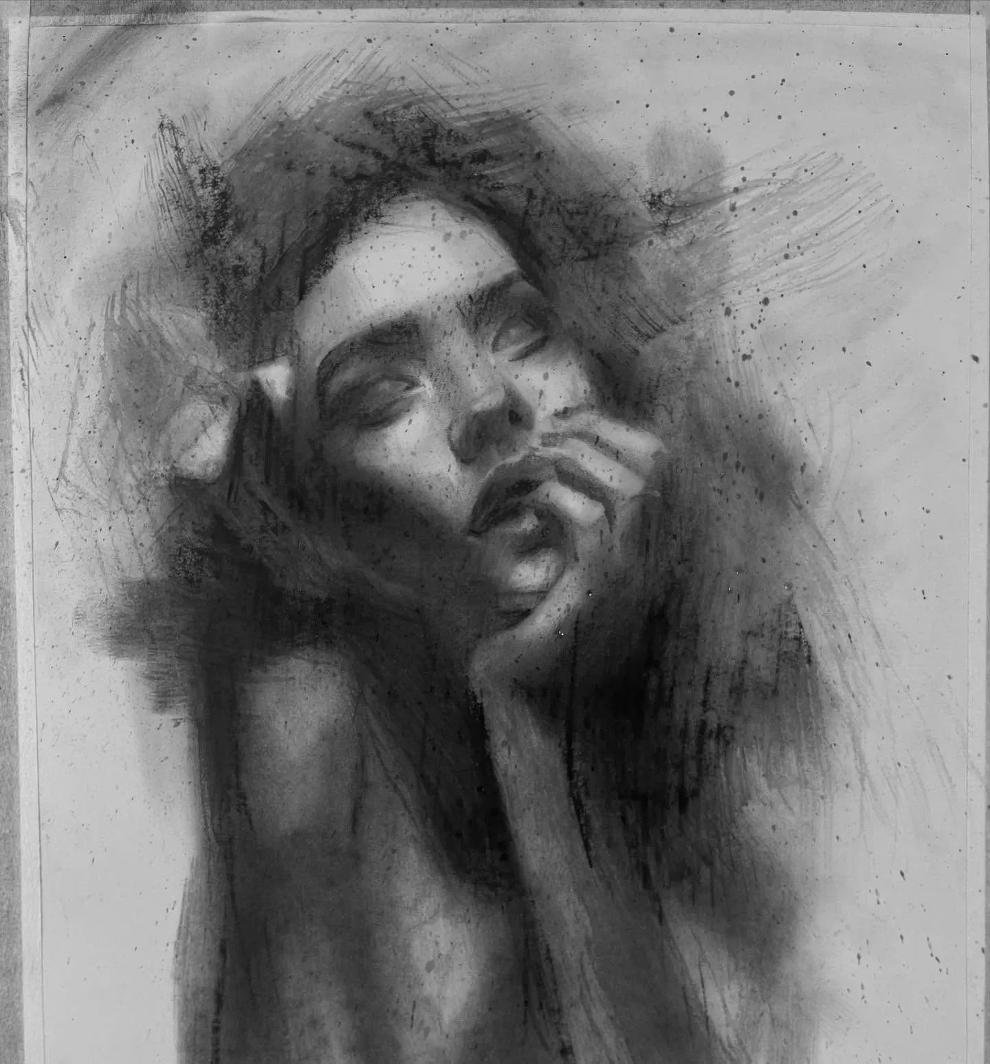 Charcoal portrait of a woman with her hand to her face
