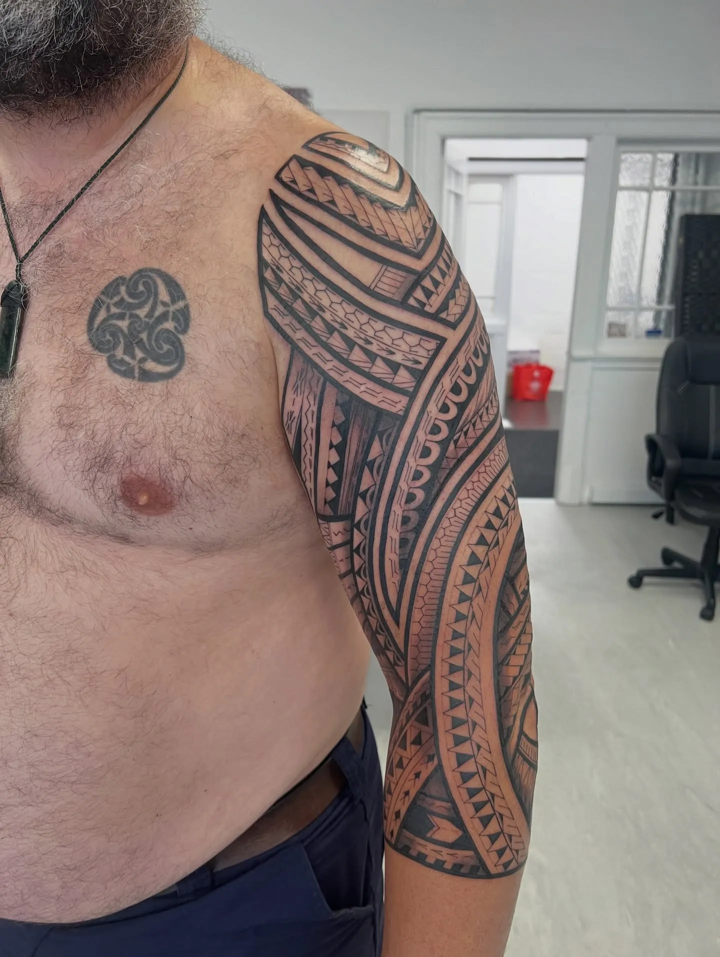 Polynesian tatau half sleeve across the shoulder and upper arm