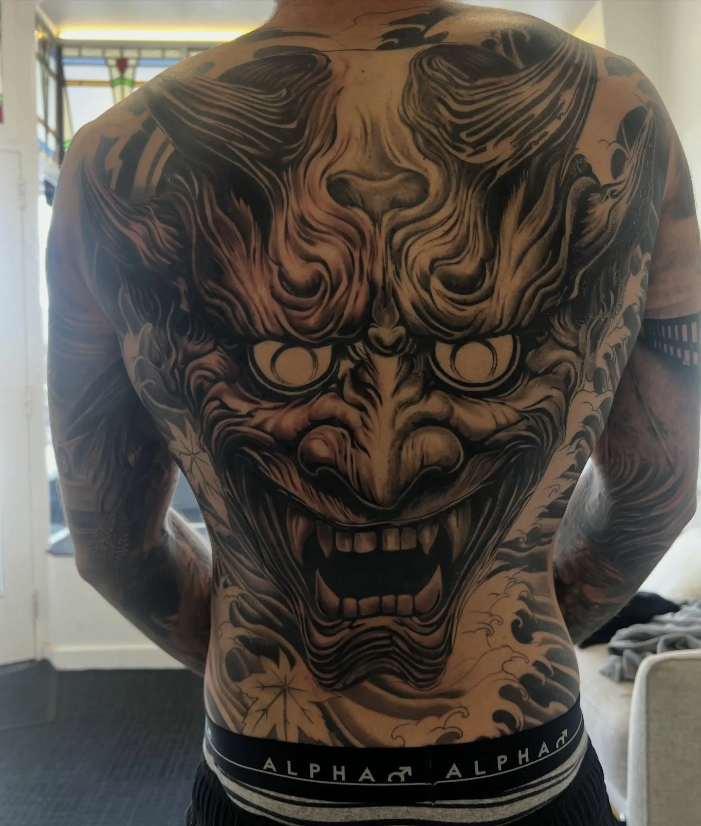 Full back piece of a demon mask in black and grey
