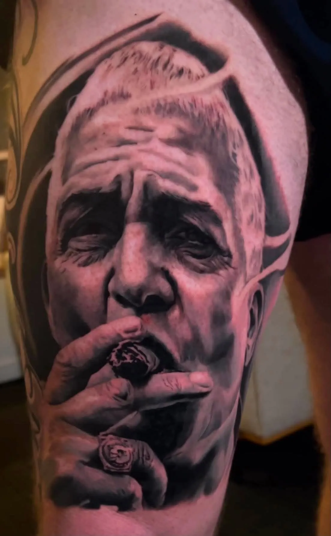 Black and grey realism portrait of an older man smoking a cigar