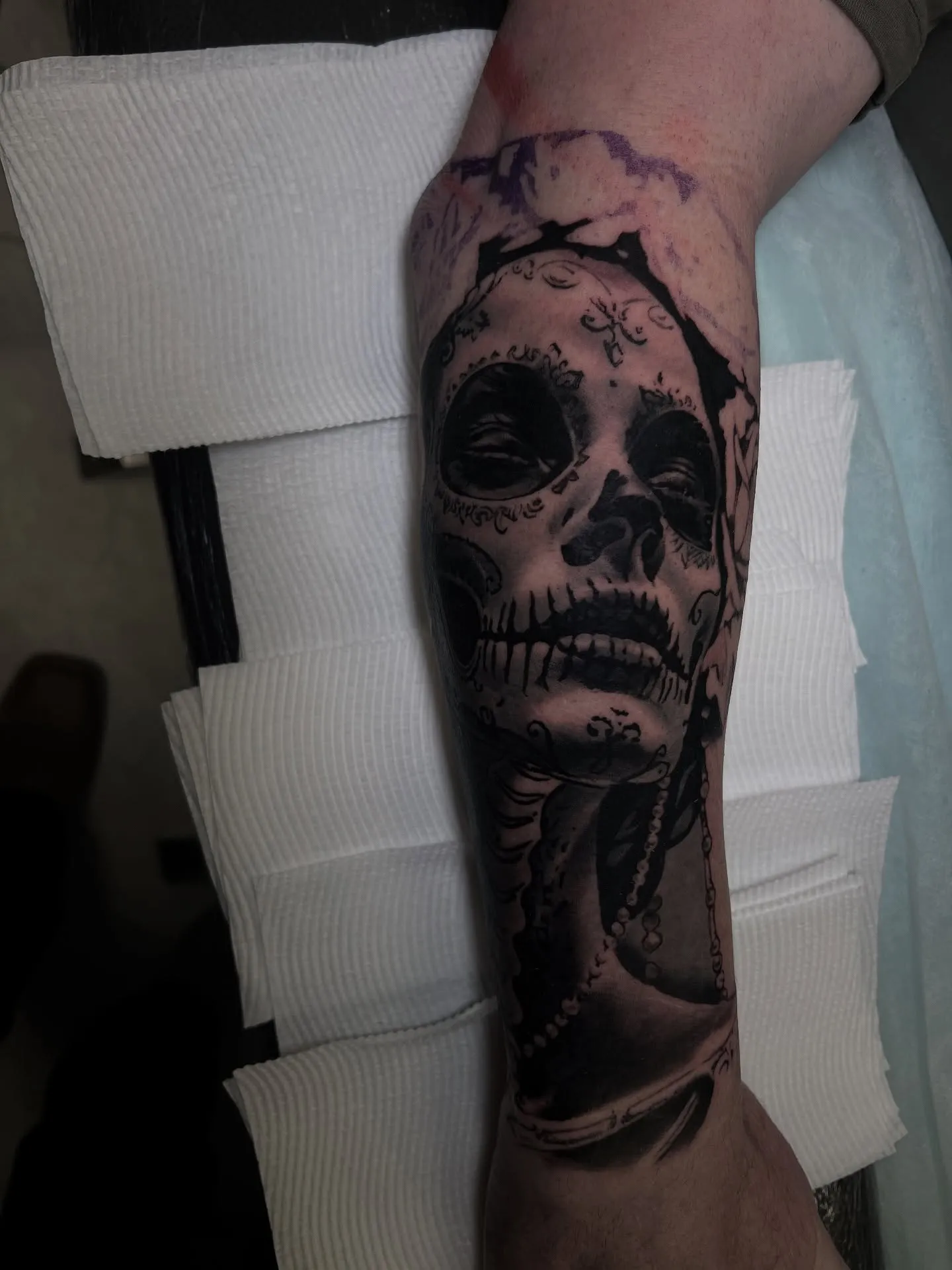 Black and grey sugar skull portrait of a woman on the calf