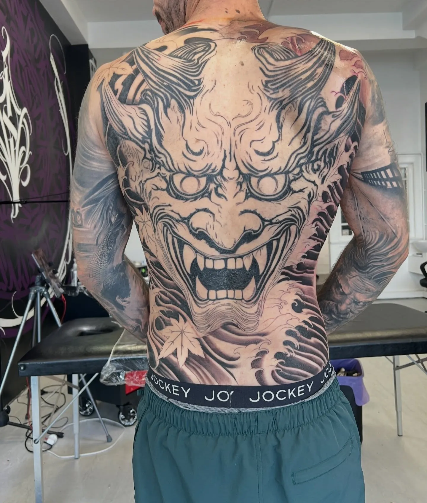Finished full back piece of a demon mask in black and grey